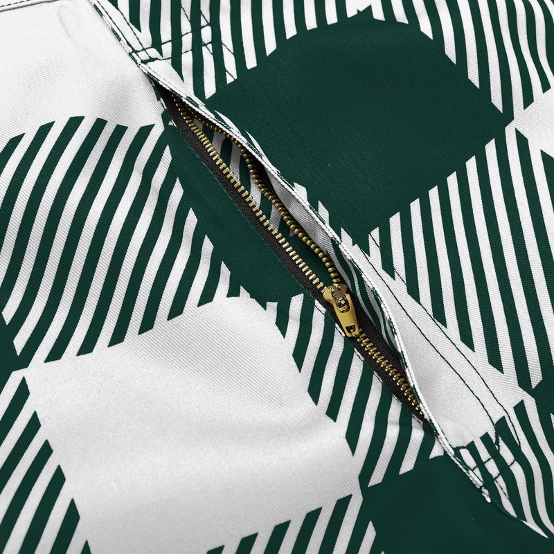 Close up of the zipper pocket of green and white plaid Michigan State overalls. 