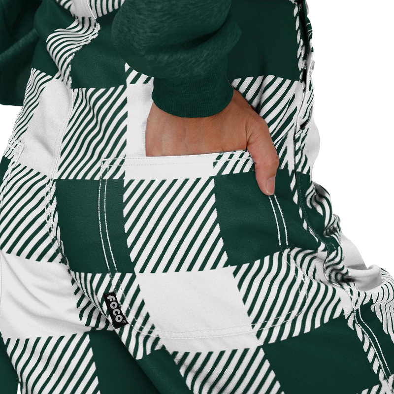 Close up of the back pocket of green and white Michigan State University overalls.