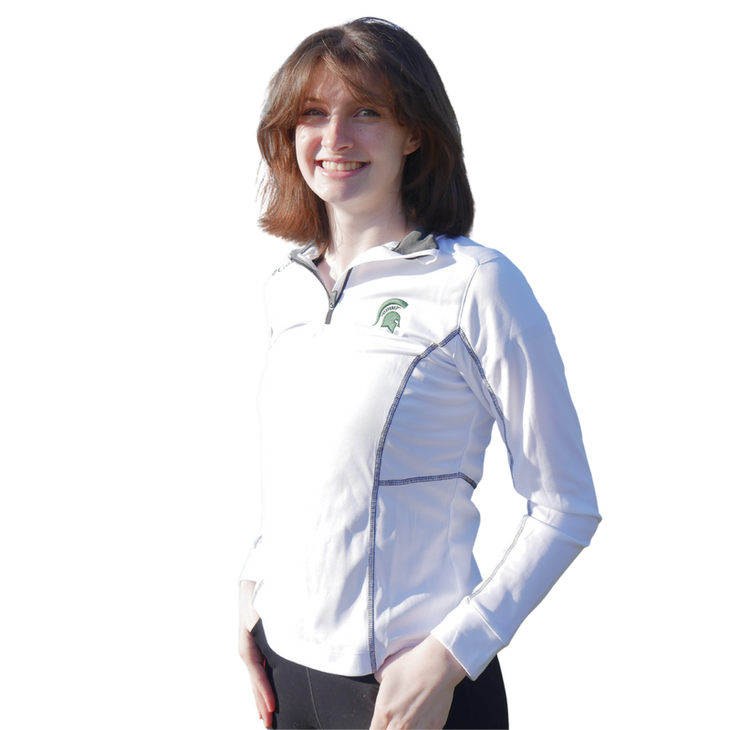 A woman wearing a white women's Columbia quarter-zip with black contrast stitching and a green Spartan helmet at left chest. Columbia is labeled at right shoulder.