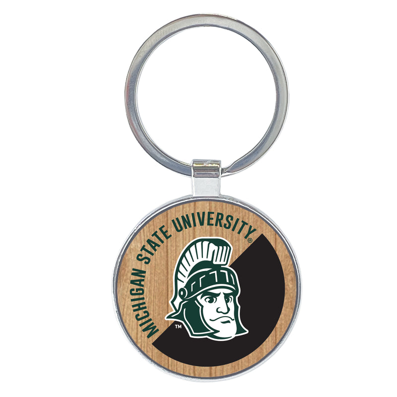 A round wooden key tag made of natural wood. It features the words "Michigan State University" arching over Sparty's head on a half-tone black printed background. The key tag is attached to a silver ring of approximately its same size.