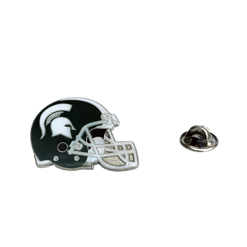 Silver metal is cutout in the shape of a football helmet and enameled in dark green and white following the MSU classic helmet style. To the right is the butterfly clutch fastener from the back of the pin.