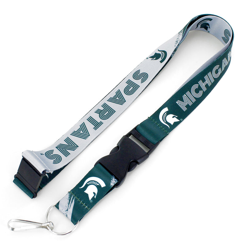 A green and white Michigan State Spartans lanyard with repeating Spartan helmet pattern on both sides. It features a safety clasp, round ring, and J-hook at the end.