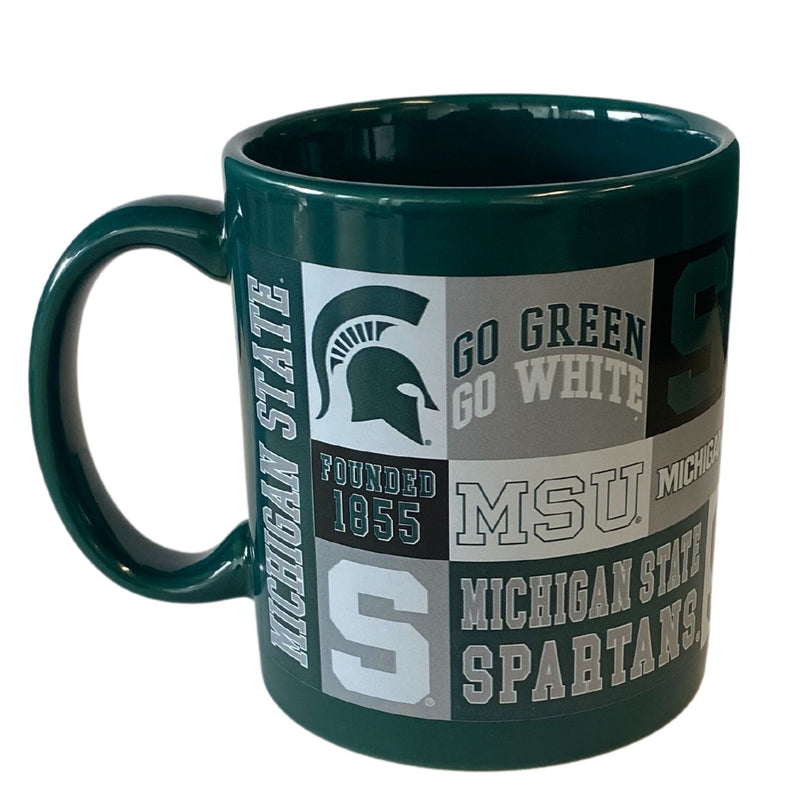 Dark green mug with several MSU branded elements, such as a green Spartan helmet in a white square, Go Green Go White, MSU, and a block S.
