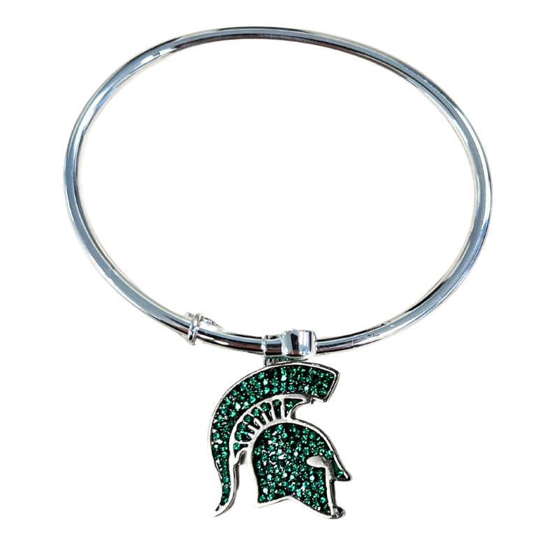 A silver, bangle style bracelet with a Michigan State spartan helmet logo medallion that is filled with green crystals.