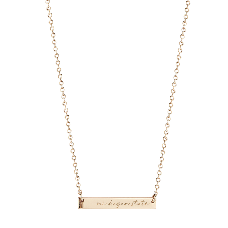 A gold, cable chain necklace with a silver bar at the bottom that reads Michigan State in cursive.