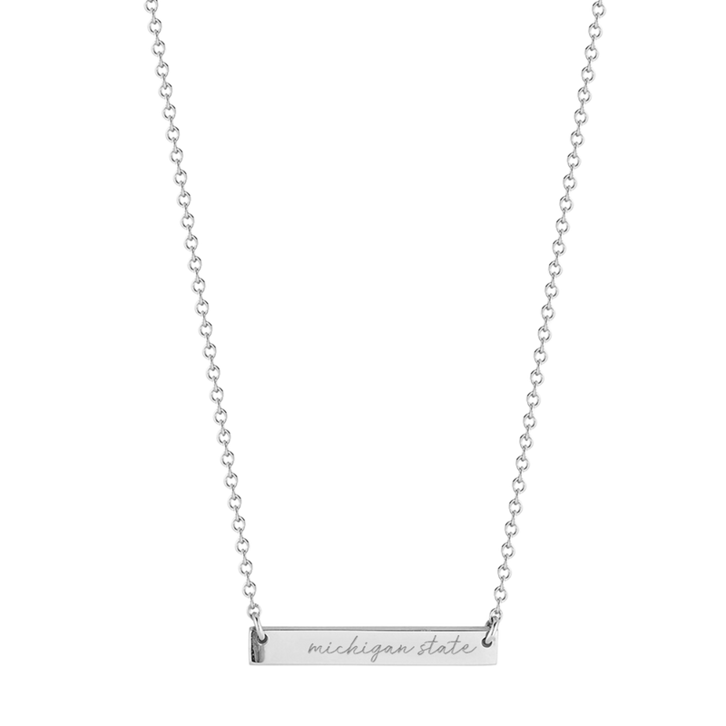 A silver, cable chain necklace with a silver bar at the bottom that reads Michigan State in cursive. 