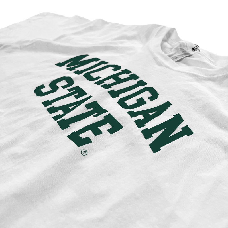 Close up of the chest area of a white t-shirt. Forest green block letters read "Michigan State" across two lines, with "Michigan" slightly arched.