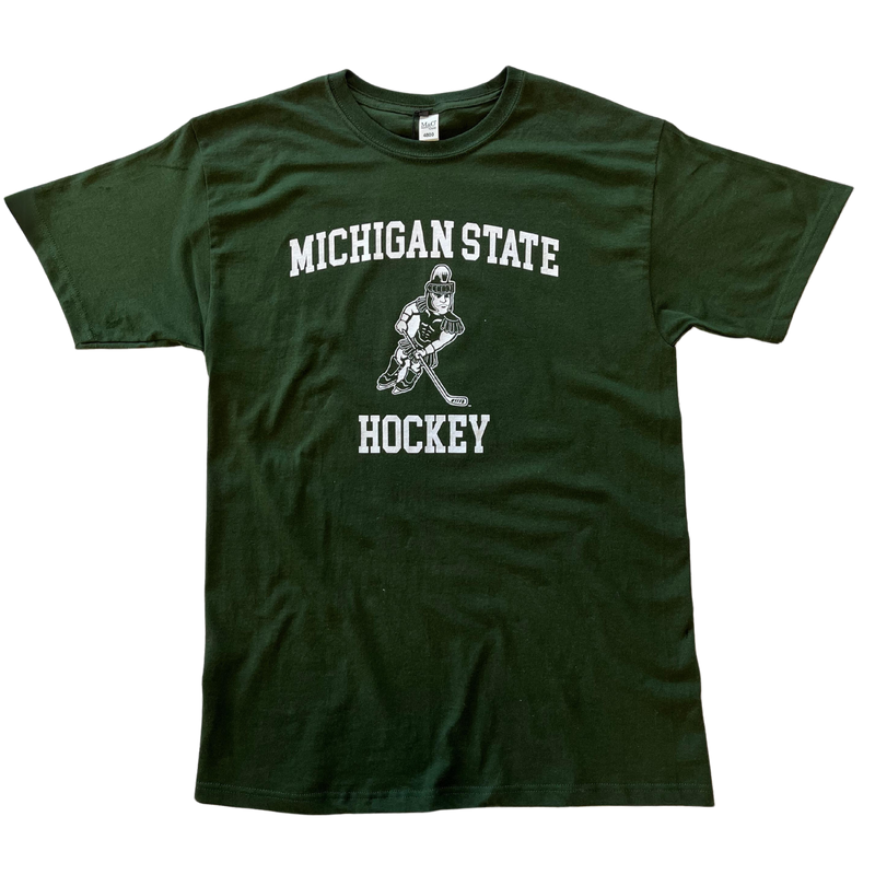 Forest green crewneck t-shirt with short sleeves. Centered on the chest, white block letters read “Michigan State” in a slight arch over an illustration of Sparty playing hockey. Below Sparty, additional white block letters read “Hockey.”