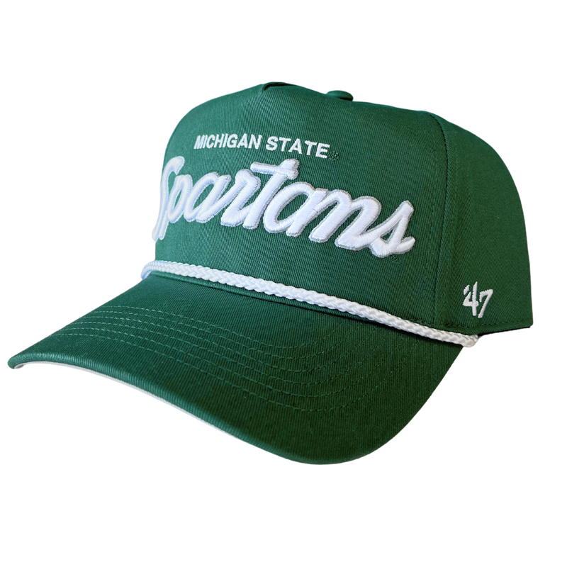 An angled view of a green baseball cap with Michigan State embroidered in white above an embroidered stylized script reading “Spartans” in white with a silver outline. Embroidered on the left temple panel features an embroidered ’47 logo in white. Over the bill is a white braided cord.