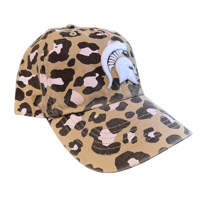 An angled view of a khaki baseball cap composed of a dark brown and pink leopard print. On the front panel is an embroidered white Michigan State Spartan helmet logo. 