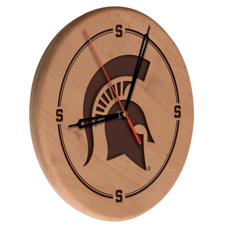 A wooden clock with a MSU spartan helmet logo engraved in the middle. Block S logos are engraved on the 12 o'clock, 3 o'clock, 6 o'clock, and 9 o'clock locations. 