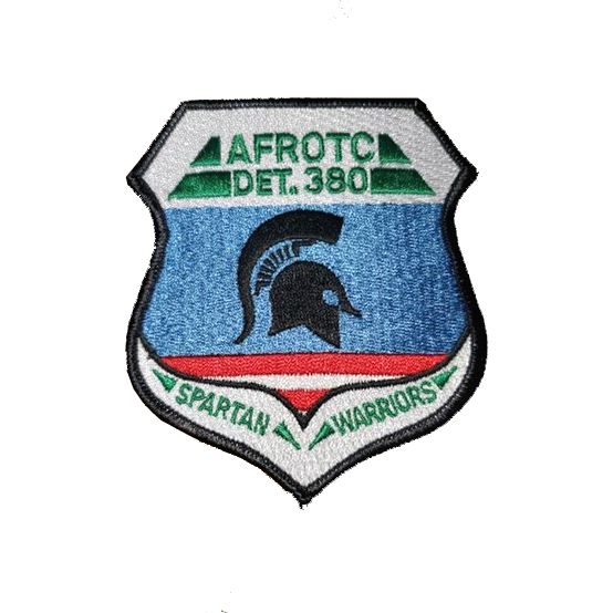 Vintage style patch in the shape of a badge. The top white section reads AFROTC DET 380 with green wings. The center is a blue bock with a black Spartan helmet over a few red and white stripes. The bottom white sections reads Spartan Warriors in green.
