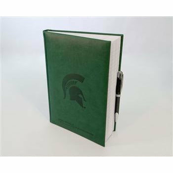 Kelly green leather-looking journal standing slightly open with lined pages and a black pen held on the outside. The cover is embossed with a Spartan helmet and the College of Human Medicine wordmark.