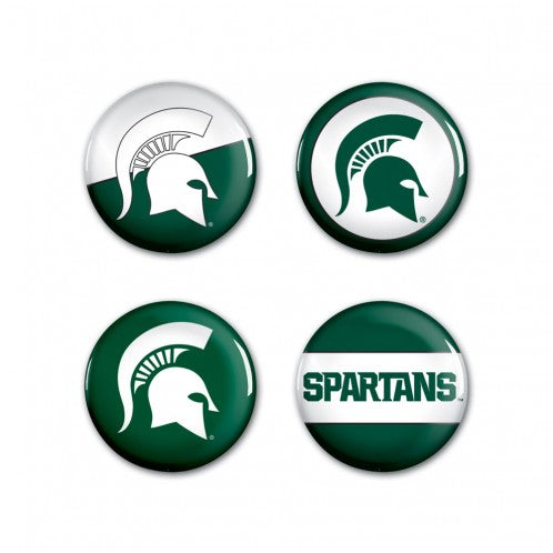 Four circular pin buttons with varying green and white patterns representing MSU.