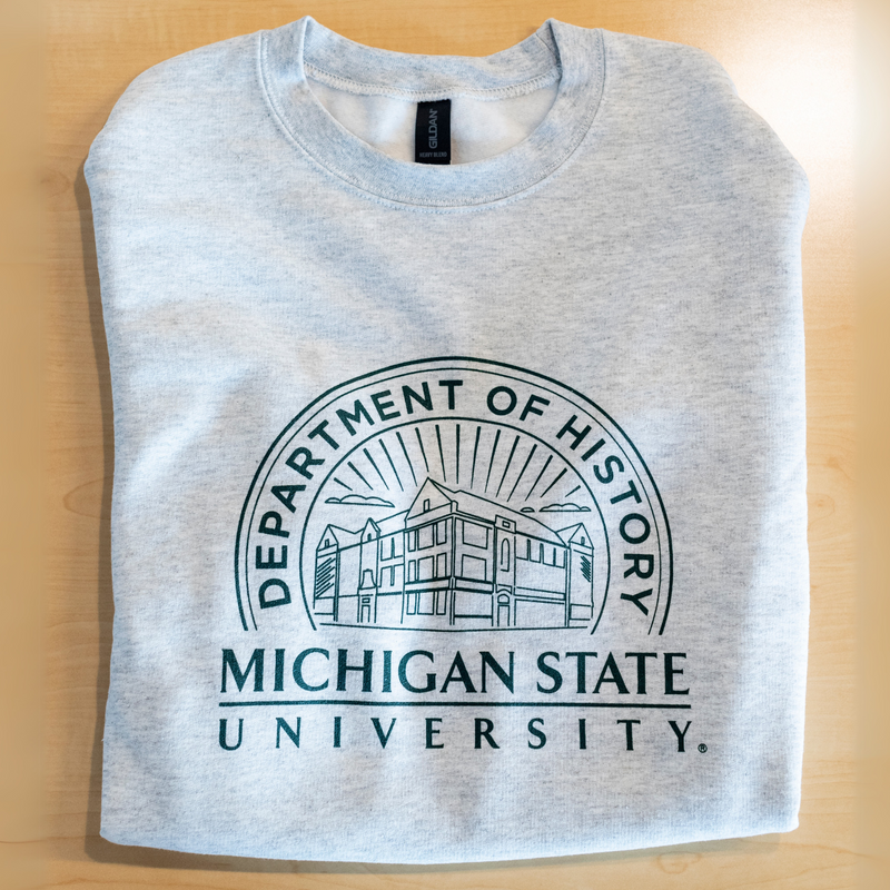 Grey crewneck sweatshirt that showcases the Old Horticulture building surrounded by the text ‘Department of History’ and ‘Michigan State University’. 