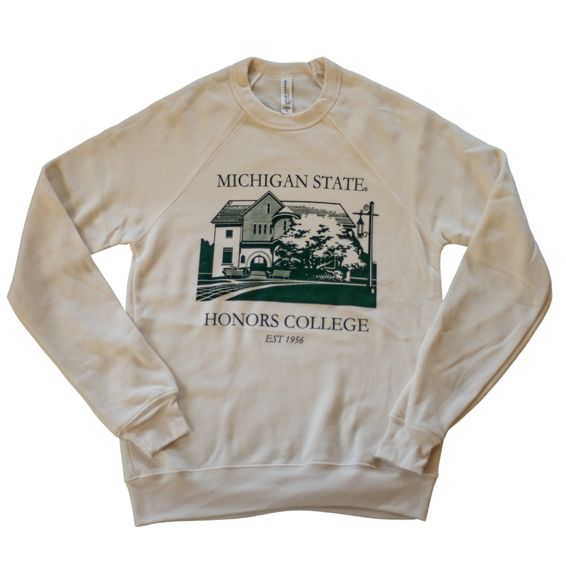 A natural/tan colored crewneck sweatshirt. On the torso of the sweatshirt in green is an image of the first MSU honors college building. Around the image is the text "Michigan State Honors College est. 1956."