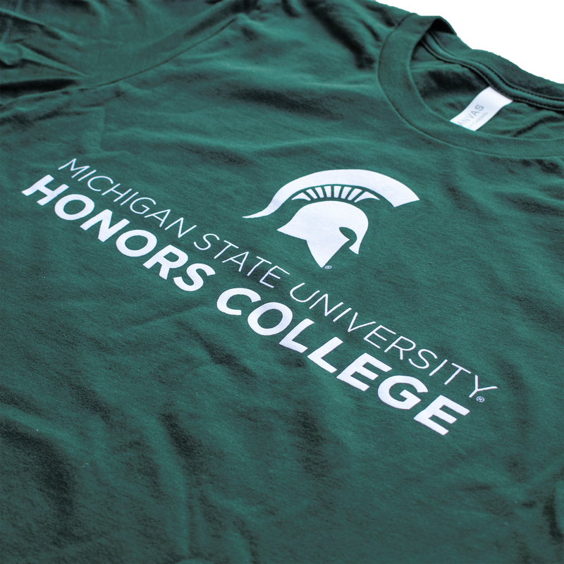 A forest green tee shirt with a white MSU spartan helmet logo. Underneath the logo, in white, is the text "Michigan State University Honors College."