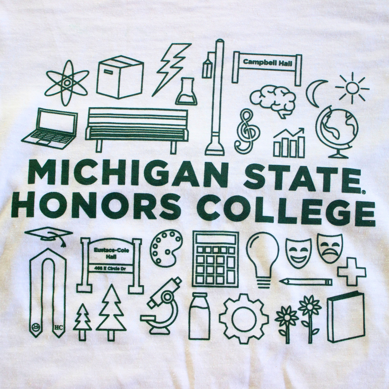 A white t-shirt featuring various forest green icons representing Honors College student interests, studies, and landmarks. The icons include symbols such as a graduation cap, a bench, a globe, a light bulb, theatrical masks, and a tree. The forest green text in the middle of the icons reads: "Michigan State Honors College."