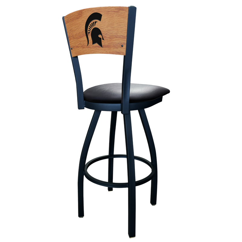 A black swivel bar stool with a black seat cushion and seat back with a wooden finish. Engraved in the seat back is a black MSU spartan helmet logo. 