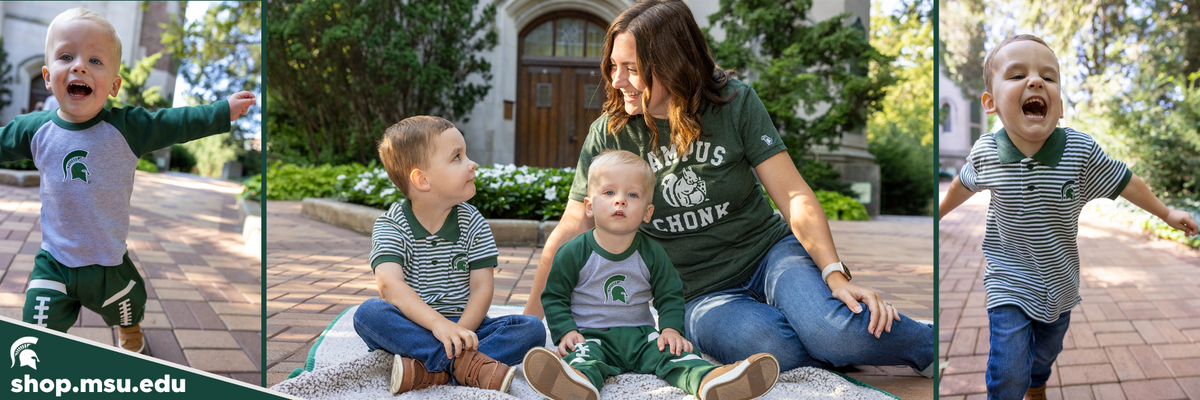 A woman with her two children wearing Michigan State University apparel and sitting on a blanket in front of Beaumont Tower as Michigan State University. 