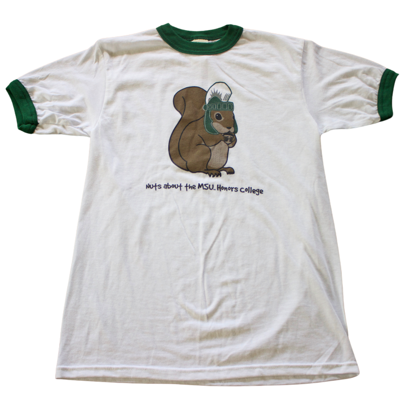 A white t-shirt with green trim on the collar and sleeves. The shirt features a cartoon image of a brown squirrel wearing a Spartan helmet. Below the squirrel, black text reads: "Nuts about the MSU Honors College." 