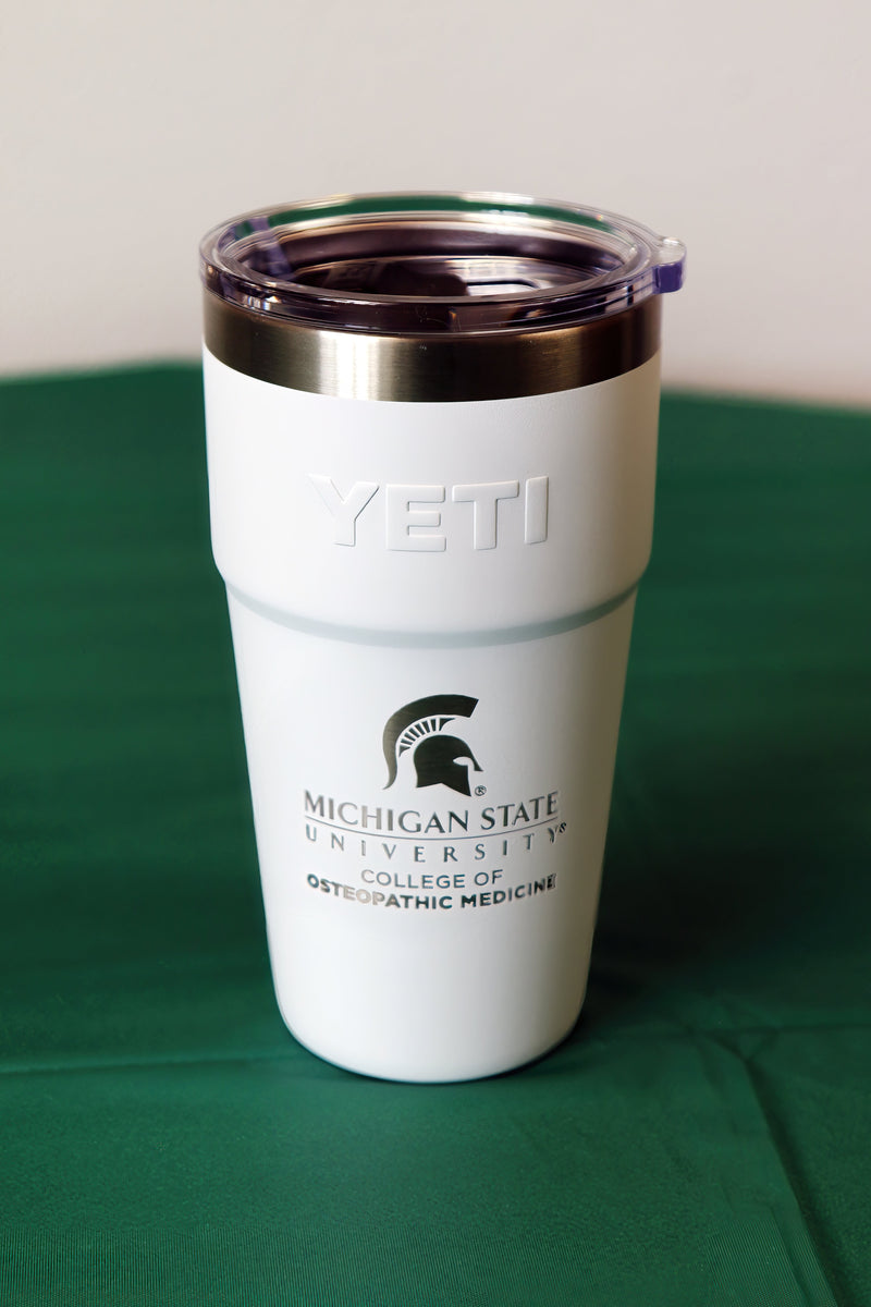 White stainless steel Yeti tumbler with MSU College of Osteopathic Medicine logo etched on side. 