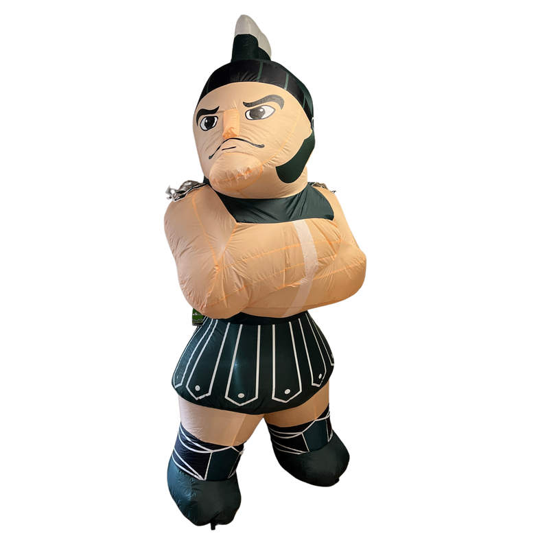 Inflatable replicate of the full Sparty mascot, with a closed lip smile and arms crossed