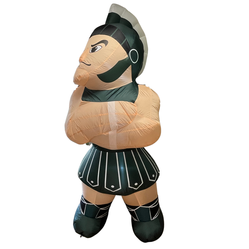 Inflatable replicate of the full Sparty mascot, with a closed lip smile and arms crossed