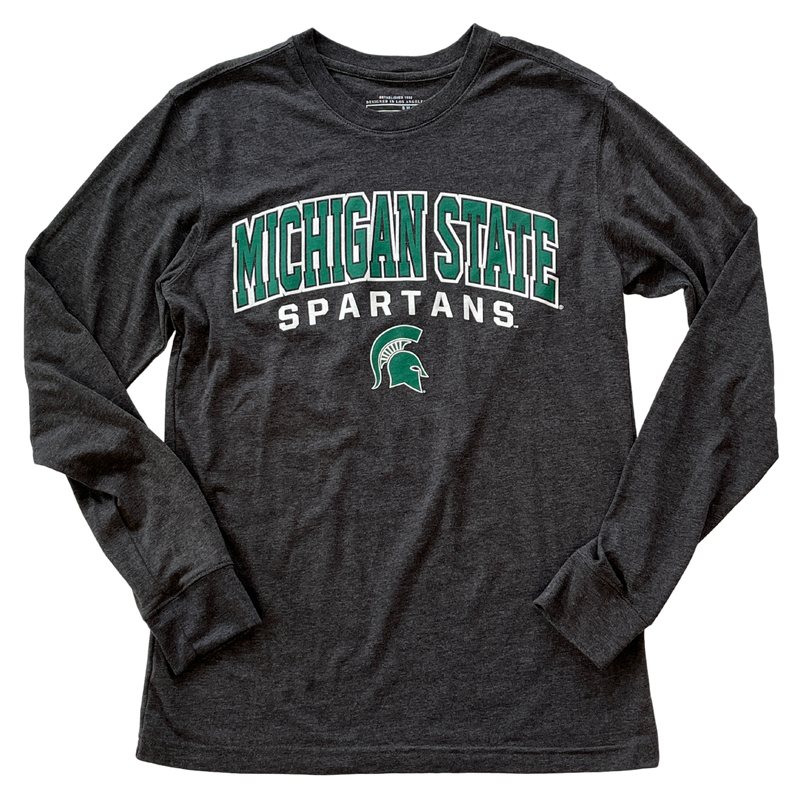 Charcoal long-sleeve t-shirt with green and white printing on the center chest. The two lines of text are slightly curved over a small green Spartan helmet with a white outline. The top line reads Michigan State in green block letters with a white outline, and the bottom line reads Spartans in white block letters.