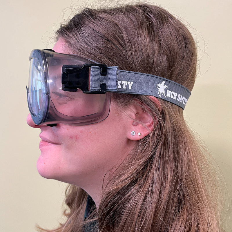 A woman wearing a pair of eye goggles with a gray headband.