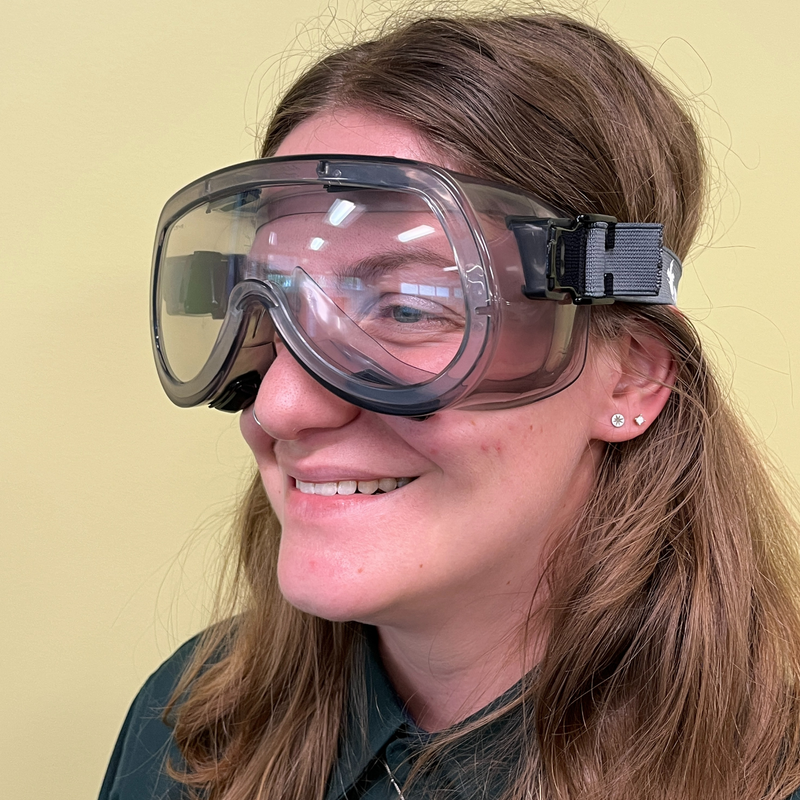A woman wearing a pair of eye goggles with a gray headband.