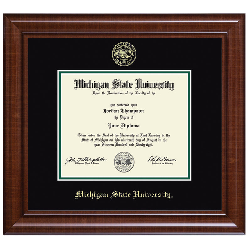 MSU diploma inside a strip of black mat. Top black mat is embossed with the MSU seal at the bottom. Frame is a very dark reddish wood