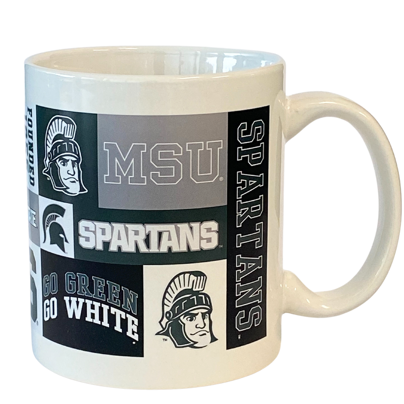 White ceramic mug with a variety of MSU logos in green, gray, white, and black.