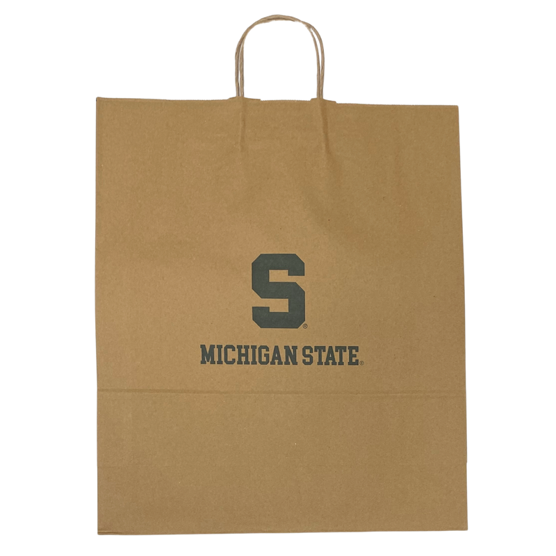 A brown heavy-weight kraft paper gift bag. It's 16 inches wide, 19 inches tall, and six inches deep. The bag features a white block S logo and the words "Michigan State" in a collegiate font. At the top are thin brown handles made of twisted paper.