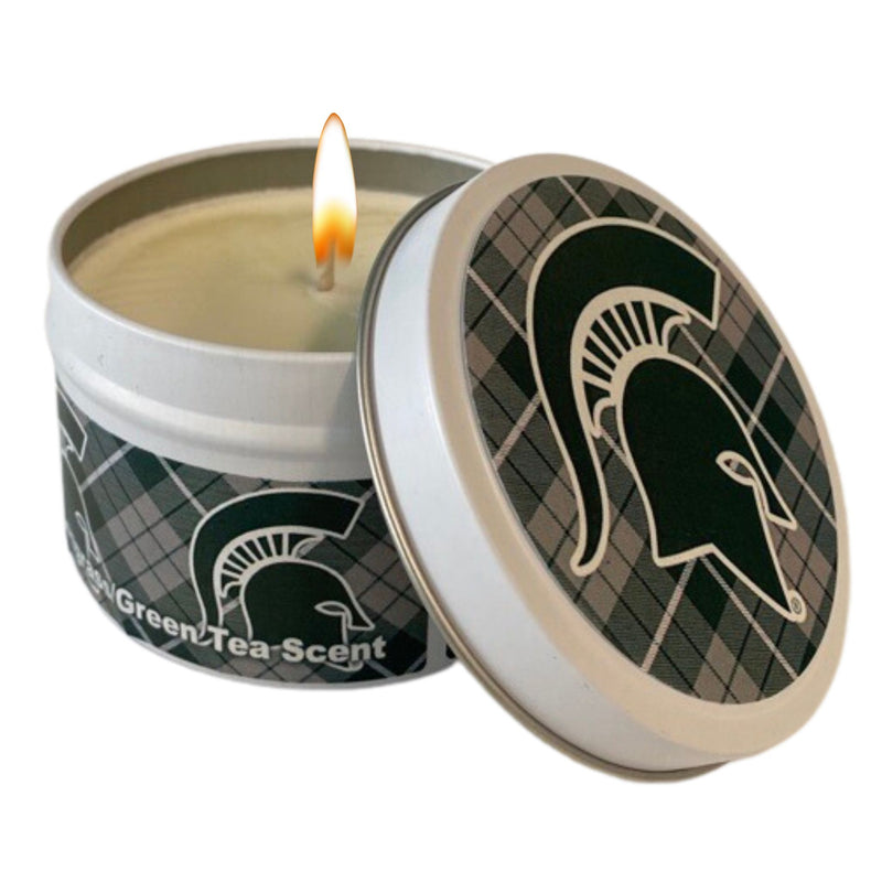 Small, lit white candle tin with the lid lying against the tin. Plaid green, gray, and white motif with a green Spartan helmet around tin and on top. Reads Lemongrass and Green Tea Scent on tin.