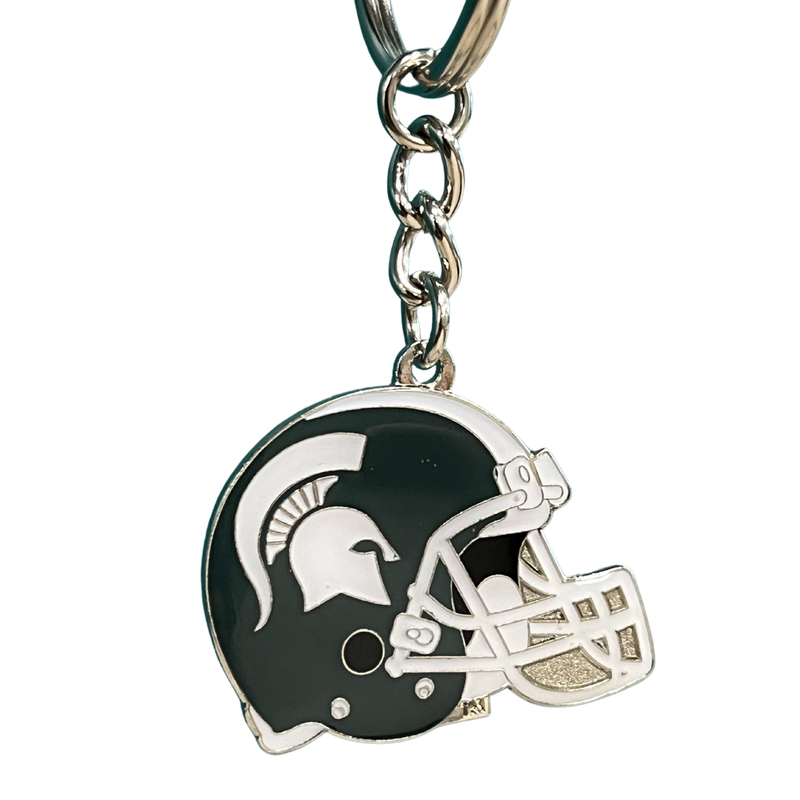 Silver metal is cutout in the shape of a football helmet and enameled in dark green and white following the MSU classic helmet style. Attached by a silver chain is a detachable keyring.