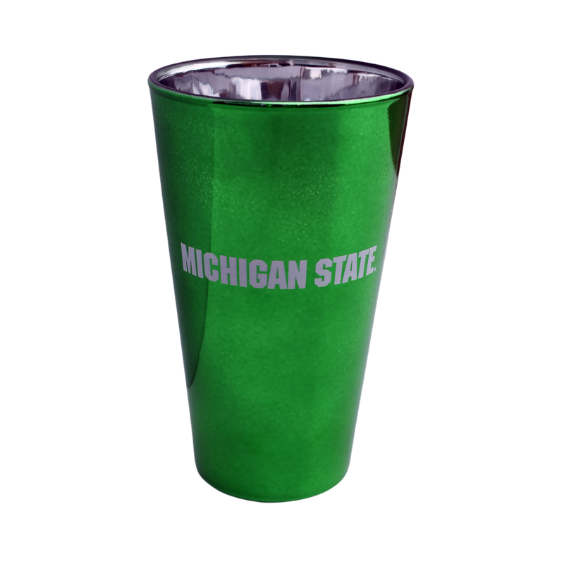 Green pint glass with a reflective chrome interior. Wrapped on one side is text spelling out Michigan State in all caps.