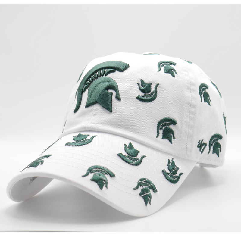 A white ball cap with multiple dark green Michigan State Spartan helmet logos scattered across the hat. A larger dark green helmet logo is in the center of the hat. 