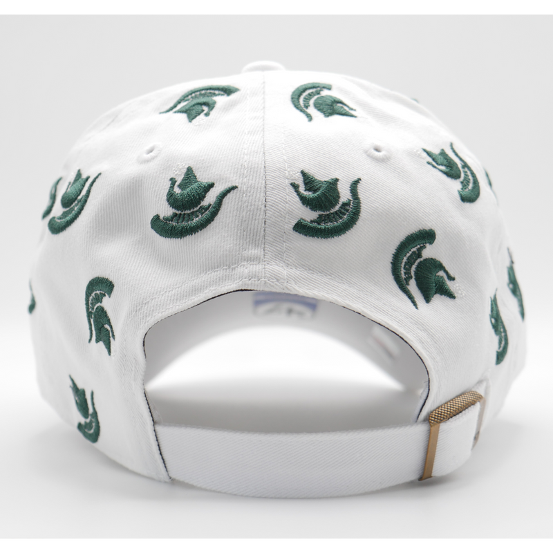 The back of a white ball cap with multiple dark green Michigan State Spartan helmet logos scattered across the hat. A bronze adjustable fastener is shown to adjust the hat's size. 