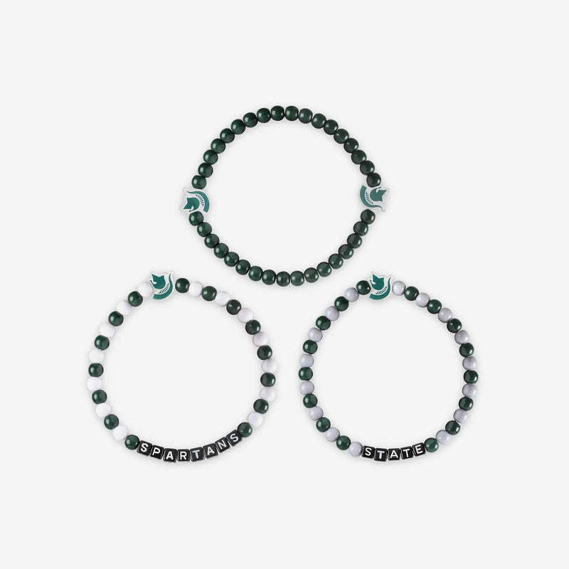 Three beaded bracelets. Two are alternating green and white beads (one has Spartans the other has State in lettering), the third is all forest green. All three have a Spartan helmet charm, the all forest green bracelet one has two helmet charms.