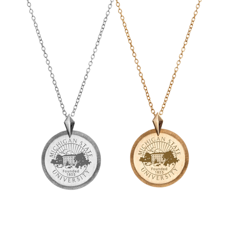 A collection of a sterling silver and gold coin necklaces, each with the Michigan State University seal in the middle of the coin medallion.