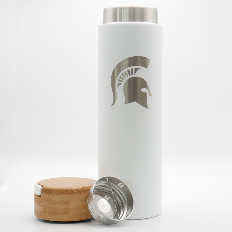 Cylinder powder coated white tumbler. Bamboo lid. Spartan helmet design etched vertically on body of tumbler. The bamboo cap and stainless steel diffuser are sitting to the left of the bottle. 