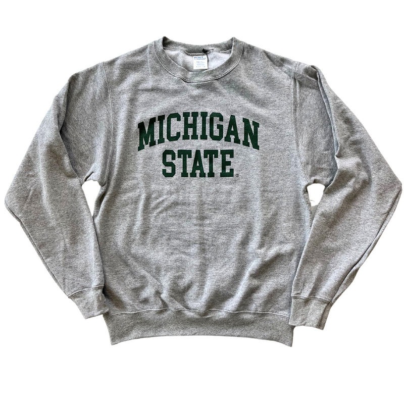 Heather gray crewneck sweatshirt. Centered on the chest, dark green block letters "Michigan State" across two lines, where “Michigan” is slightly arched.