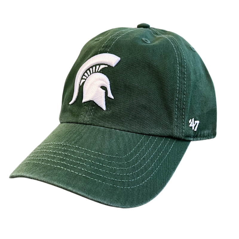 An angled view of a dark green ball cap with a white Michigan State spartan helmet logo embroidered on the center face of the hat. On the left temple panel is a white embroidered '47 logo