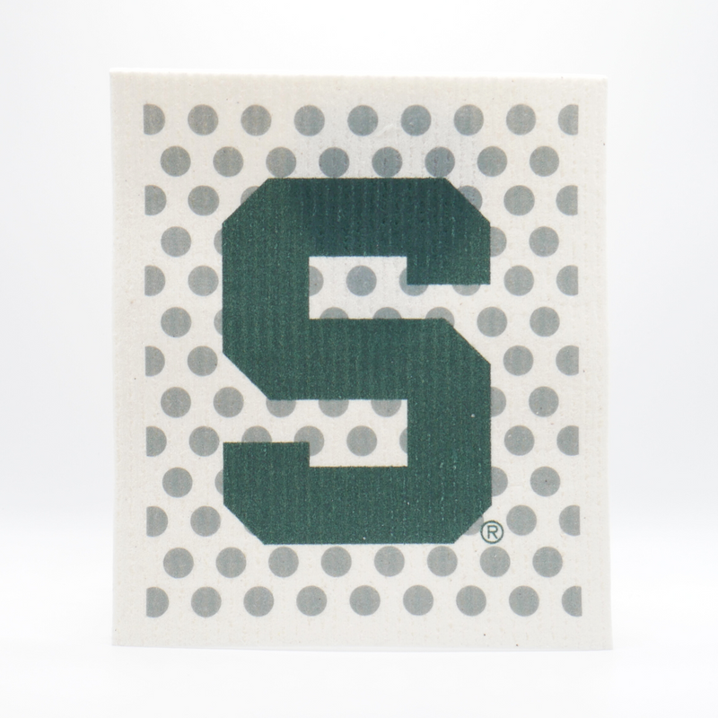 A cream re-usable absorbent square dish cloth with a gray polka-dot pattern. In front of the pattern in the center of the dish cloth is a dark green Michigan State block S logo. 