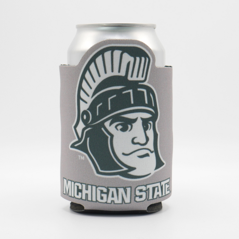 The side of a 12 fluid ounce beverage insulator in gray with a dark green Sparty head logo and the word "Spartans" written on it. 