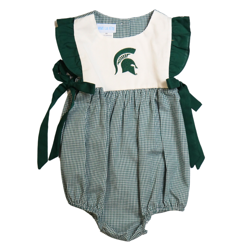 Front of a sleeveless baby jumper. The green and white plaid bottom has a bubble effect in shape. The top is white with dark green ruffle trim ending in bows at the hip. A dark green Spartan helmet is printed on the center chest.