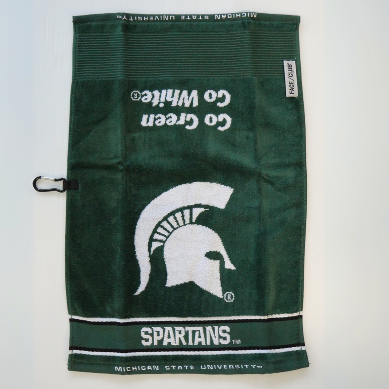 A dark green golf towel with a large white MSU Spartan helmet logo in the center. Underneath the logo is the word "Spartans" written in all caps in white, followed by a smaller print "Michigan State University." Above the helmet logo, facing the opposite direction, are the words Go Green Go White in italics. 