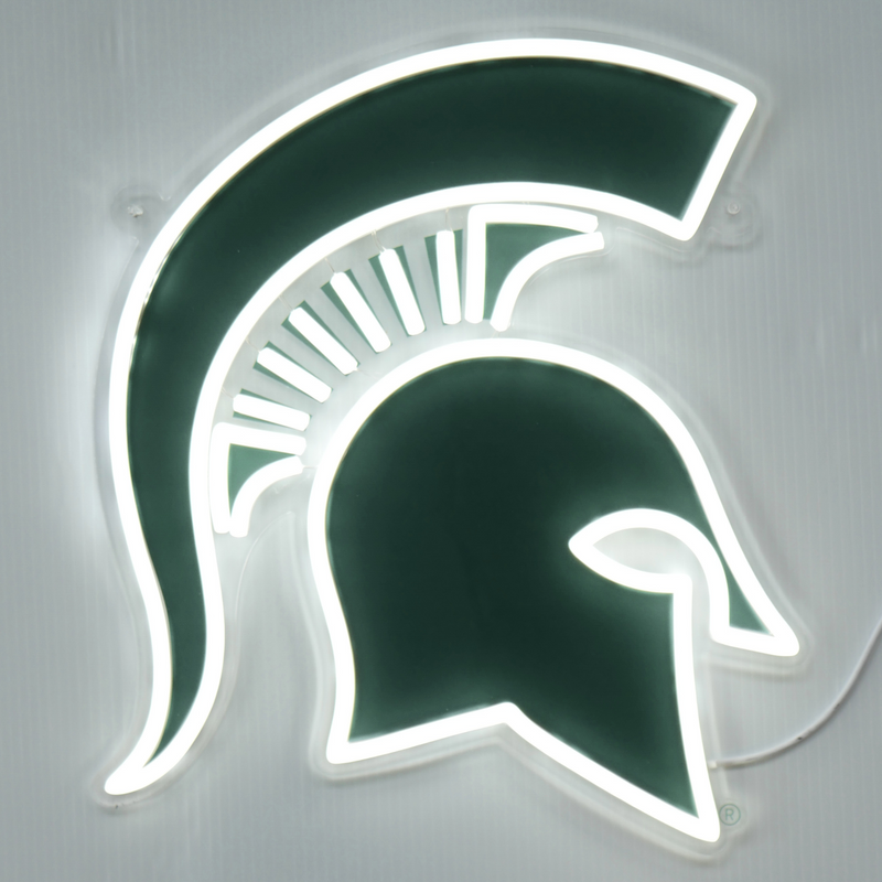 A neon wall sign that shows a green Michigan State Spartan helmet logo. Outlining the green logo are white neon lights. 