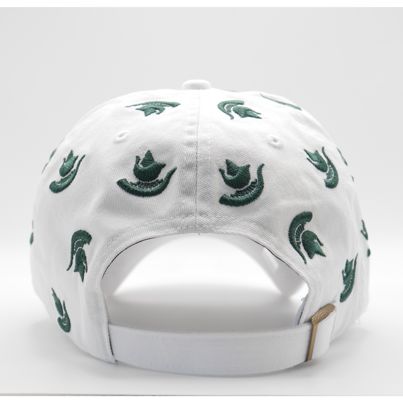 The back of a white ball cap with multiple dark green Michigan State Spartan helmet logos scattered across the hat. A bronze adjustable fastener is shown to adjust the hat's size. 